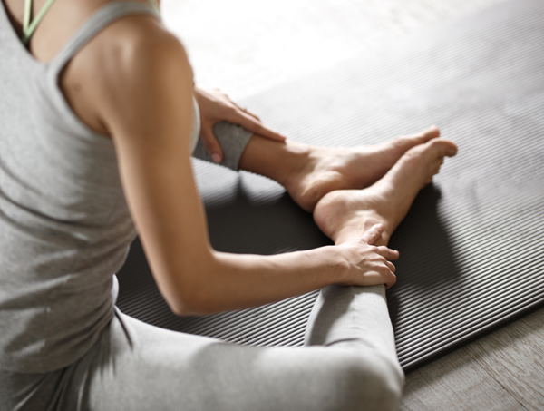 person doing a yoga stretch on a mat focusing on flexibility and balance in a relaxing environment ideal for two key stretches for well being